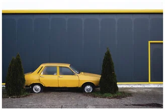 Photo art by Olah Laszlo-tibor: playful yellow car in an urban setting