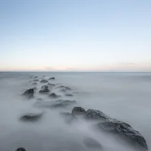 Gentle sea waves under a clear sky, radiating tranquility.
