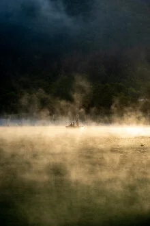 Photo art by Christian Köster: fishermen at dawn on a calm lake in Bosnia