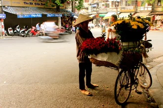 Photo art by Marisa Pettit: flower seller on a busy street in Hanoi
