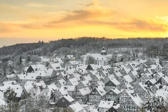 Winter scene of Freudenberg featuring half-timbered houses and soft evening colors.