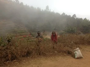 Smiling child in the foggy landscape of Mambo, Tanzania.
