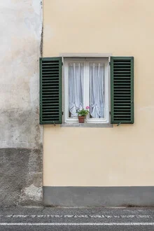 Yellow wall with a window and plant, calm atmosphere in an Italian room.