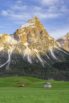 Photo art by Michael Valjak: Evening light over the Tyrolean Alps with meadows and huts.