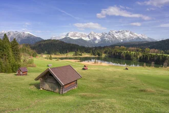 Spring day at Lake Geroldsee in Bavaria: tranquil landscape with gentle hills and blue sky