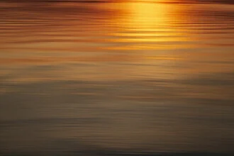 Blurred sunset at the Baltic Sea with soft golden hues.