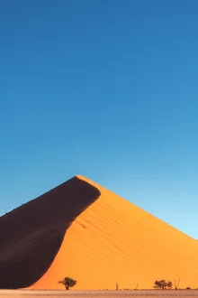 Photo art by Jean Claude Castor: peaceful sand dune under blue sky at sunset