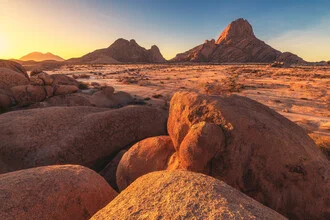 Photo art by Jean Claude Castor: Sunset over rugged rocks in Namibia