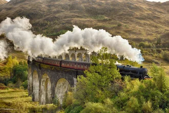 Steam train crossing the Glenfinnan Viaduct in the Scottish Highlands.