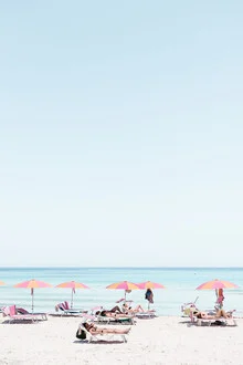 Image of an Italian summer beach scene with gentle waves and a clear sky.
