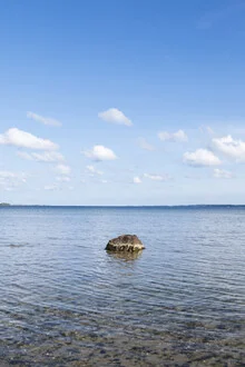 Calm Baltic Sea with gentle waves and stones by the shore