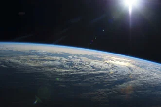 Photo art by Nasa Visions: Earth depicted from space in soft colors.