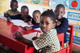 Photo art: Schoolgirl in Uganda, surrounded by a friendly atmosphere