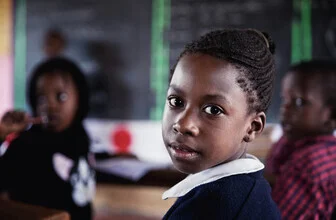 Photo art by Victoria Knobloch: schoolgirl in Uganda engaged in learning