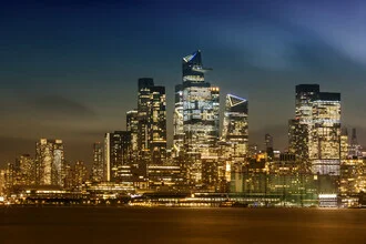 Photo art by Melanie Viola: Evening NYC skyline with illuminated skyscrapers.