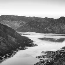 Panoramic view of Kotor with fog over the sea and soft morning light.