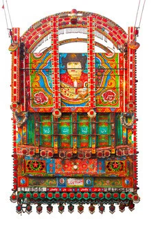 Colorful truck from Pakistan adorned with vibrant motifs.