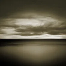 Dramatic seascape: gentle waves under a cloudy sky