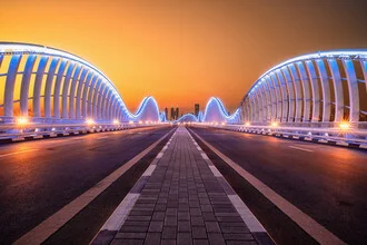 Photo of Meydan Bridge in Dubai at sunset, capturing a serene cityscape.