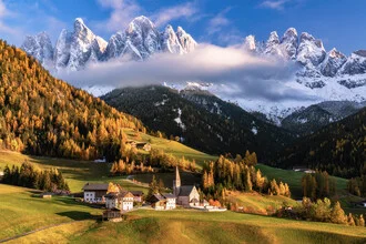 Colorful autumn landscape in South Tyrol with larches and the Geisler mountains