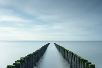 Photo art by Rolf Schnepp: breakwaters on the Zeeland coast at sunset