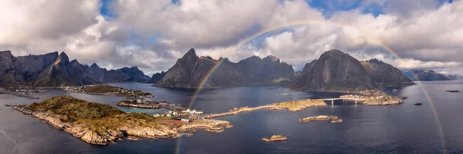 Panoramic view of Lofoten with colorful houses by the fjord and a rainbow