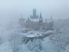 Blizzard over Marienburg Castle with snow-covered architecture in winter