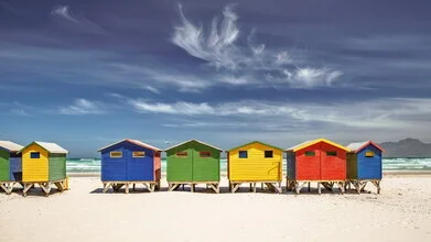 Colorful beach houses in Muizenberg, a calming atmosphere by the sea.
