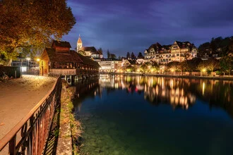 Evening mood at Lake Thun with illuminated church and autumn colors.