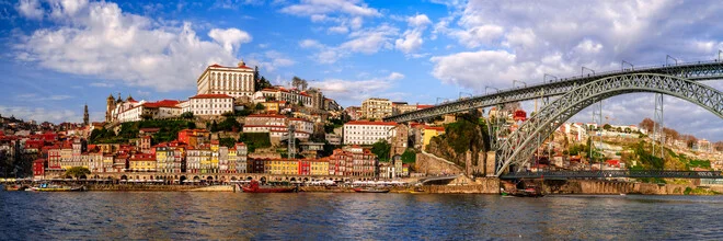 Cityscape of Porto: panorama featuring riverbank and bridge in soft light