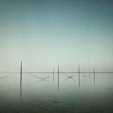 Photo by Manuela Deigert: tranquil coastal landscape with posts and water reflections