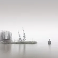 Photo art by Dennis Wehrmann: fog over Hamburg's harbor city with cranes.
