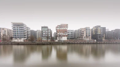 Panorama view of Hamburg harbor in fog, soft colors and calm atmosphere.