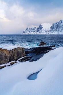Photo art by Eva Stadler: blue tear drop above snow-covered mountains in Norway.