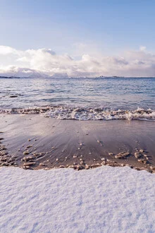 Snow-covered beach in Norway with soft pastel colors and a calm mood.