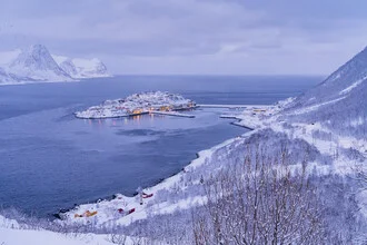 Husøy on Senja, Northern Norway: tranquil winter landscape with snow-covered mountains and a bay