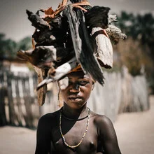 Portrait of a Himba boy in Namibia, soft colors and genuine expression.