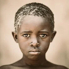 Portrait of a boy from Zambia with expressive eyes and a contemplative gaze.