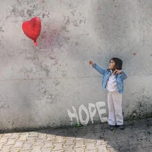 Photo of a girl with a balloon, radiating hope for return.