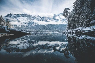 Winter landscape at Lake Eib with snow-covered mountains and calm water surface