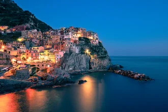 Photo art by Achim Thomae: view of the illuminated village of Manarola by the Mediterranean Sea.