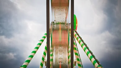 Photo art by Christoph Kalck: fairground with rides and clouds in the background