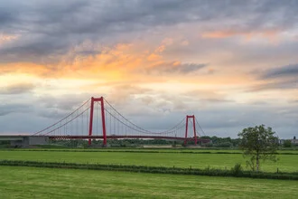 Photo of the Rhine bridge near Emmerich during a calm sunset.