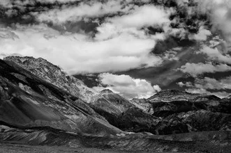 Photo art by Michael Wagener: clouds over the barren Death Valley in sunlight