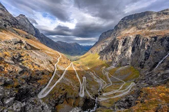 Panorama view of the Trollstigen Road in Norway, surrounded by majestic mountains.