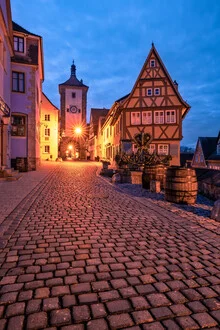 Illuminated half-timbered house in Rothenburg at blue hour, calm ambiance.