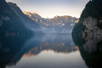 Morning scene at Lake Königssee with gentle misty clouds.