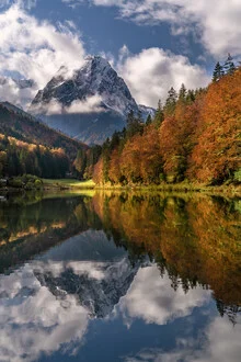 Autumn landscape featuring Lake Riessersee with reflecting mountains in the background. Autumn landscape featuring Lake Riessersee with reflecting mountains in the background.
