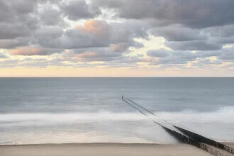Soft waves at Domburg beach with pastel tones and a calm atmosphere.