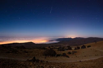 Photo art by Marco Entchev: night sky over the Canary Islands with clouds and stars.